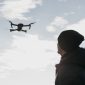 low angle man watching drone 85x85
